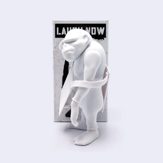 White monkey figurine with a 'Laugh Now' box on a light gray background