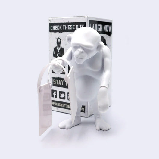 White monkey figurine with packaging on a white background