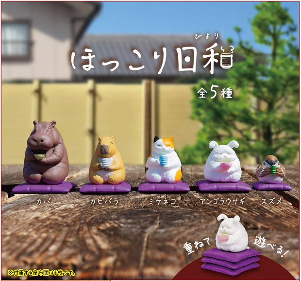 Graphic display of 5 different animal figures siting on a purple floor pillow and holding a small cup of tea. Animals are: hippo, capybara, cat, bunny and bird.
