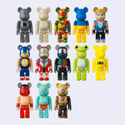 13 differently designed Bearbrick figures, designs being: grey basic, white jellybean, Jon Burgerman pattern, Ukraine flag, Street Fighter character, Sonic the Hedgehog, Japanese robot character, frog, all yellow with "inu" written on belly, Luchador, blue cartoon bear and a Hieronymus Bosch style painting.