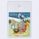 Keychain with cartoon bear and friends at a campsite on a blue background