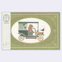 Small greeting card with a green envelope that has an oval shaped opening, revealing the illustration of the card within. Card has a bear driving an old-timey car with a bird on the hood that says "hello"