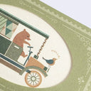 Small greeting card with a green envelope that has an oval shaped opening, revealing the illustration of the card within. Card has a bear driving an old-timey car with a bird on the hood that says "hello"