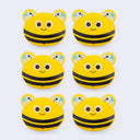 Six yellow and black bee-shaped clips on a white background