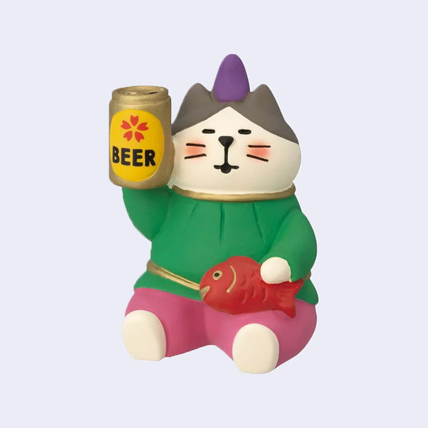 Small sculpture figure of a cat dressed in green, gold and pink and holding a red fish. It has a can of beer in its other paw and is flushed from drinking.
