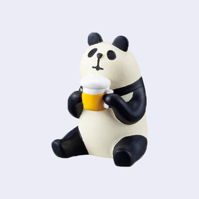 Small figure of a sitting panda, holding a frothy beer mug in its hand.