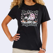 Black t-shirt with a graphic of My Melody and Kuromi, sitting together in front of a sushi conveyor belt with cherry blossoms around them. Text reads "Better Together"
