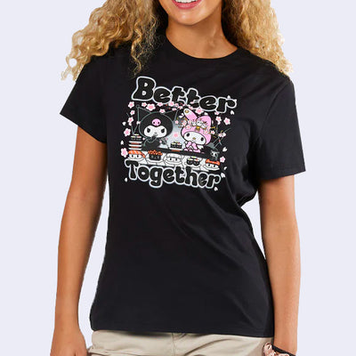 Black t-shirt with a graphic of My Melody and Kuromi, sitting together in front of a sushi conveyor belt with cherry blossoms around them. Text reads "Better Together"