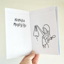 Open booklet with a drawing of a person holding a bag and a popsicle, with text on the opposite page.
