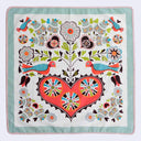 Decorative fabric square with colorful heart design and birds on a light blue background
