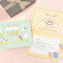 Two birthday cards with cute illustrations on a pink background