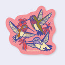 A die-cut sticker featuring an illustration of three hummingbirds and red flowers on a pink background, with the text 'Bird Collective' at the bottom, shown on a light gray background.