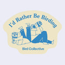 A die-cut sticker featuring a cream-colored background with a blue line-art illustration of two people birdwatching, with the text 'I'd Rather Be Birding' at the top and 'Bird Collective' at the bottom.