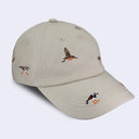 A light beige baseball cap featuring embroidered birds and a sun on the front panels and brim, set against a plain light gray background.