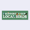 A rectangular green bumper sticker with the text 'SUPPORT YOUR LOCAL BIRDS' in large white letters, decorated with various colorful bird illustrations, and 'BIRD COLLECTIVE' printed in small white letters at the bottom right. The sticker is shown against a light gray background.