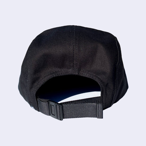 Back view of black cap, with adjustable strap to change fit.