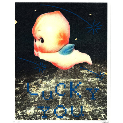 Screenprint of a lit up city at night, seen from overhead and far away as if in a plane. A large Kewpie baby flies overhead, with blue shooting stars and pixilated text that reads "Lucky You."