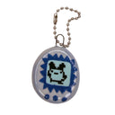 A small oval keychain or tag pendant with a pixelated character design, attached to a silver ball chain on a plain white background.