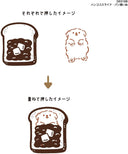 Illustration showing 2 stamped drawings of a piece of toast and of a dog.