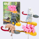 Set of small animal figurines on broom sticks with a forest-themed box in the background.