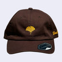 Brown cap with a yellow-orange ginkgo leaf in the middle. "Giant Robot" is written in cursive along the side of the cap.