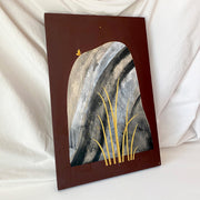 Collage style painting on solid burgundy background of a tall grey rock with bold, abstract marbling pattern and striping. A small yellow butterfly sits atop the rock and tall blades of yellow grass are in front of the rock. Displayed at an angle.