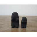 2 small wooden figurines of monkeys - one is larger than the other.