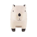 Small white wood figurine of a capybara, sitting with black color accents.