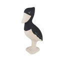 Wooden bird figurine with black and white design on a white background