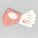 Set of pink cards with a white card featuring a fox illustration on a gray background