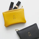 Yellow and black pouches with a small logo on a white background