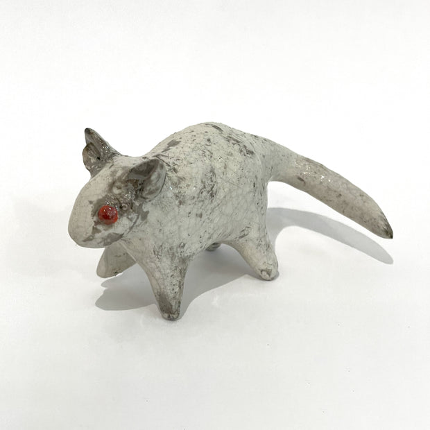 Ceramic sculpture of a gray mouse.
