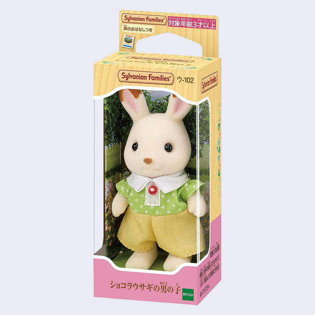 Toy rabbit figure with flocked fur, wearing a green shirt with white polka dots and yellow shorts in its product packaging box, with a clear plastic front.