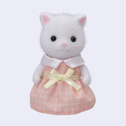 White cat figurine with flocked fur, wearing a pink checkered dress and yellow bow on a light gray background