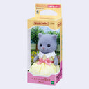 Figurine of a gray cat with flocked fur, wearing a yellow dress with a pink bow around its waist and white collar. In its product packaging.