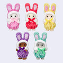 Five small plush bunny dolls arranged on a light gray background, each wearing a bunny hood and jumpsuit in a different pastel color: pink, red, yellow, purple, and mint green.