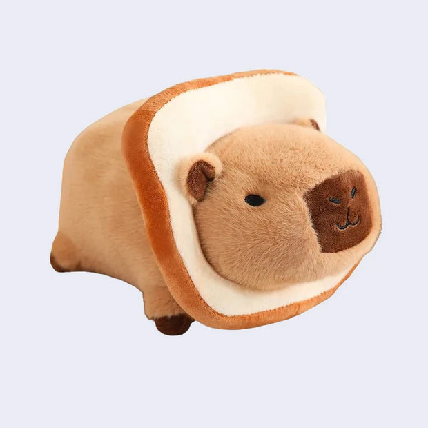 Plush capybara doll with a slice of white bread around its head, like the head punched a hole into it.