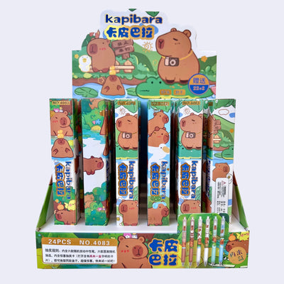 Display of Kapibara-themed pens in blind box packaging with cartoon characters on a white background