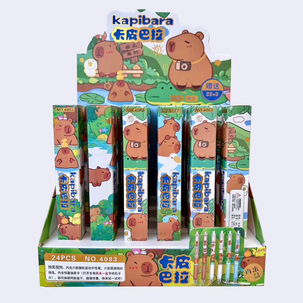 Display of Kapibara-themed pens in blind box packaging with cartoon characters on a white background