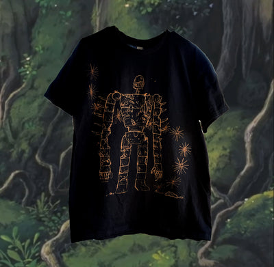 Black t-shirt with bleach colored drawing of a large robot from Castle in the Sky, with some abstract sparks nearby.