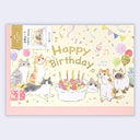 A square Japanese 'Happy Birthday' greeting card featuring cute hand-drawn cats around a birthday cake, with confetti, balloons, and musical notes on a cream background, bordered by a pink margin.
