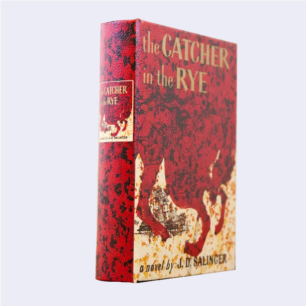 Hardcover book of "The Catcher in the Rye," made to look slightly weathered and vintage