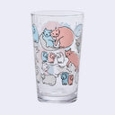 Clear glass with colorful cat illustrations on a white background