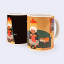 Mug with a design of an elderly woman and a cat on a couch, shown from two angles.