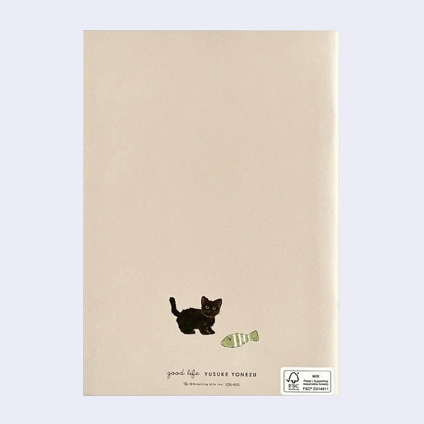 Backside of notebook, beige with a tiny black cat standing next to a fish plush.