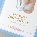 Birthday card with cat paw illustration and 'Happy Birthday' text
