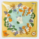 Decorative scarf with floral and nature-themed design on a yellow background