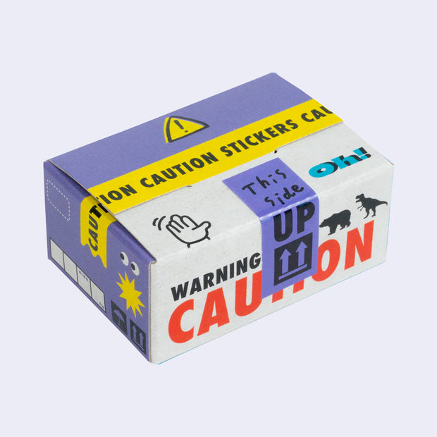 Box of stickers, made to look like a cardboard shipping box holding hazardous materials, with labeling and illustrations on the exterior that mimic the real thing.
