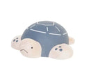Wooden figure of a gray and white turtle with a rounded shell, flat belly and cute cartoon frown.