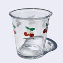 Clear glass tumbler with cherry designs and 'Chellion' branding on a white background